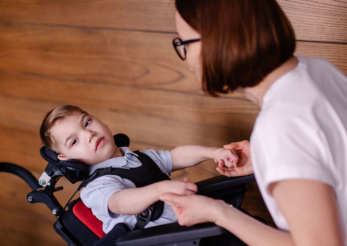 boy with cerebral palsy with his mother