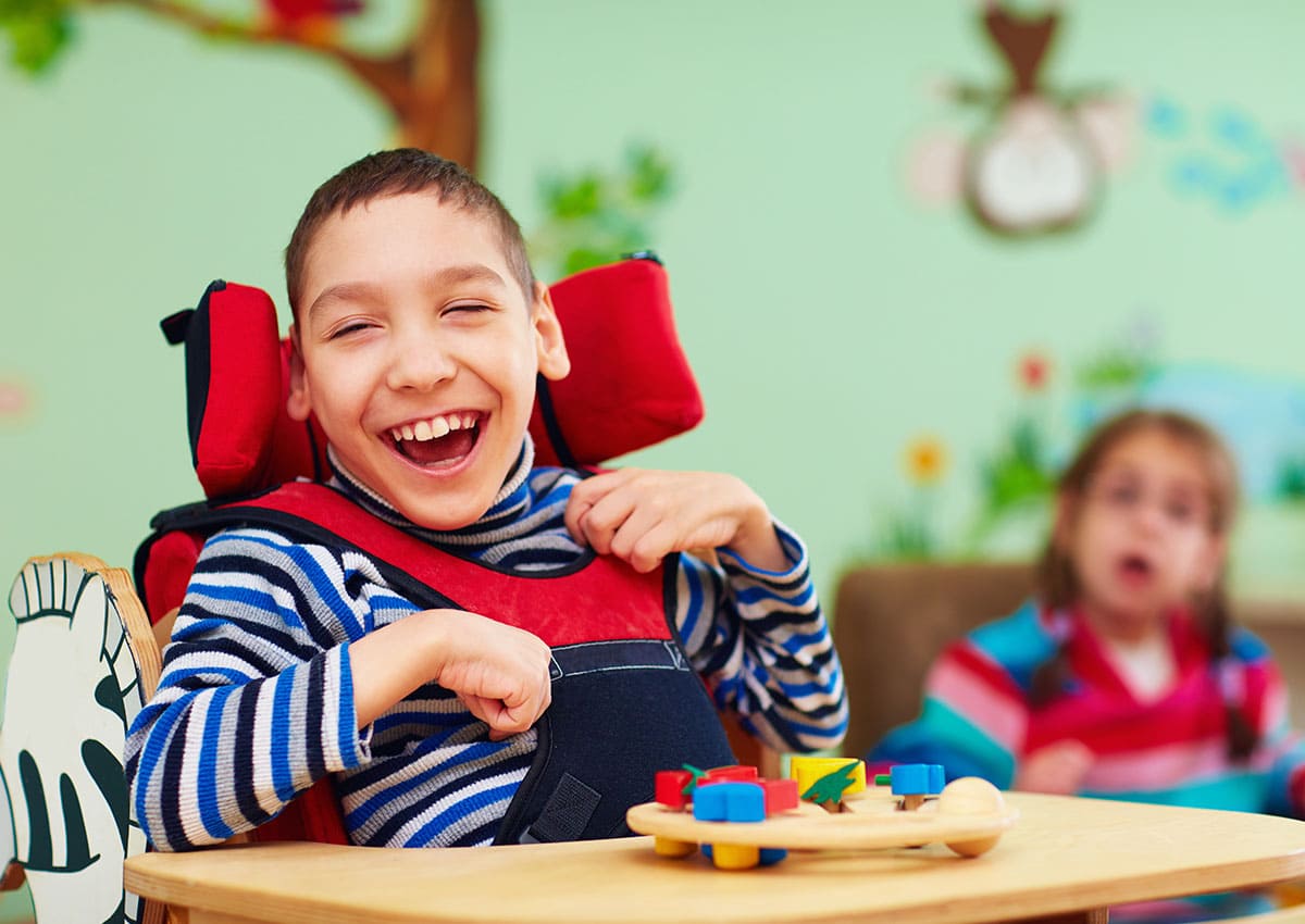 cheerful boy playing with wood toy