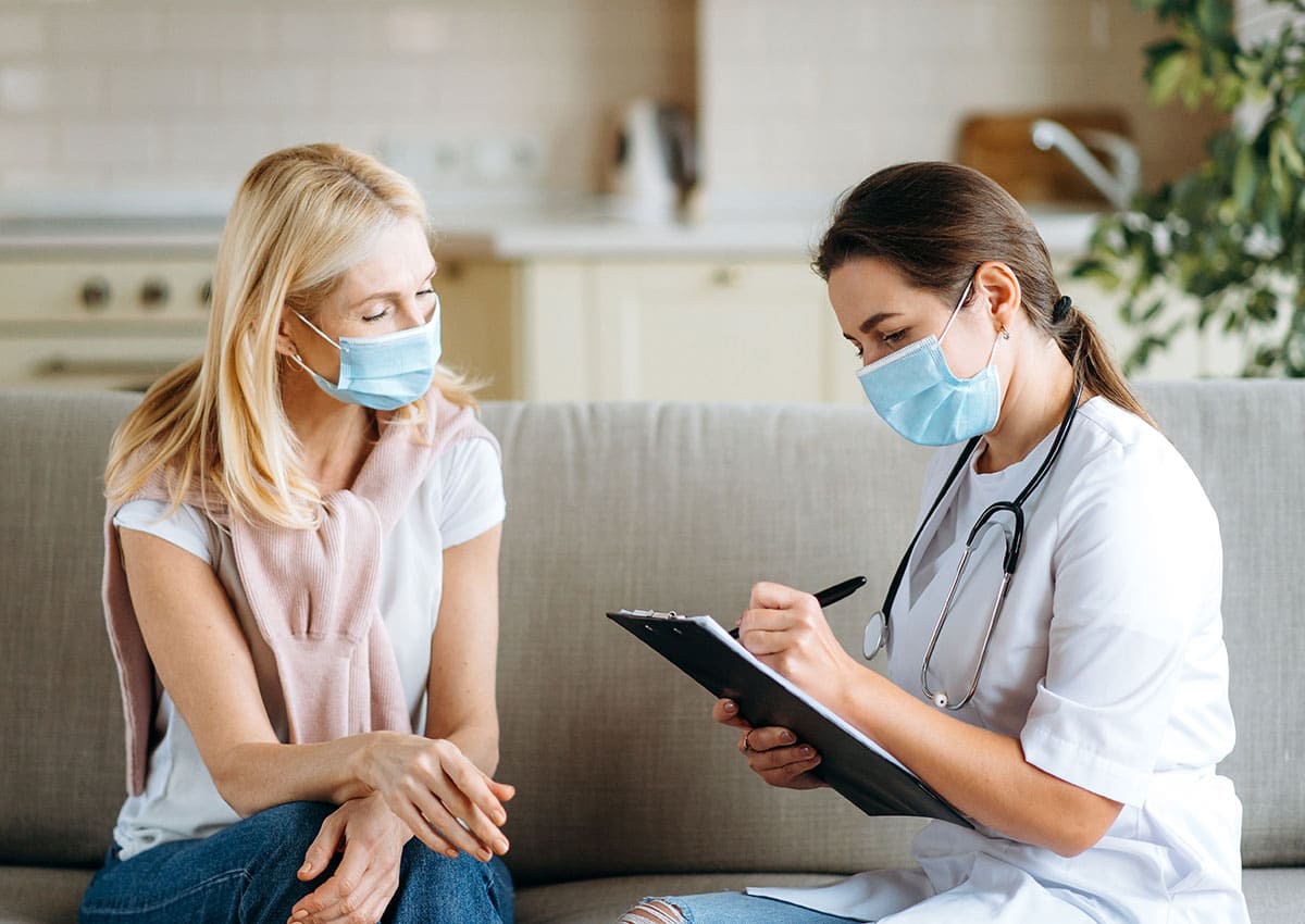 woman doctor helping middle aged woman