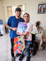 Man in blue shirt stands next to pediatric homecare patient who is holding a stuffed animal