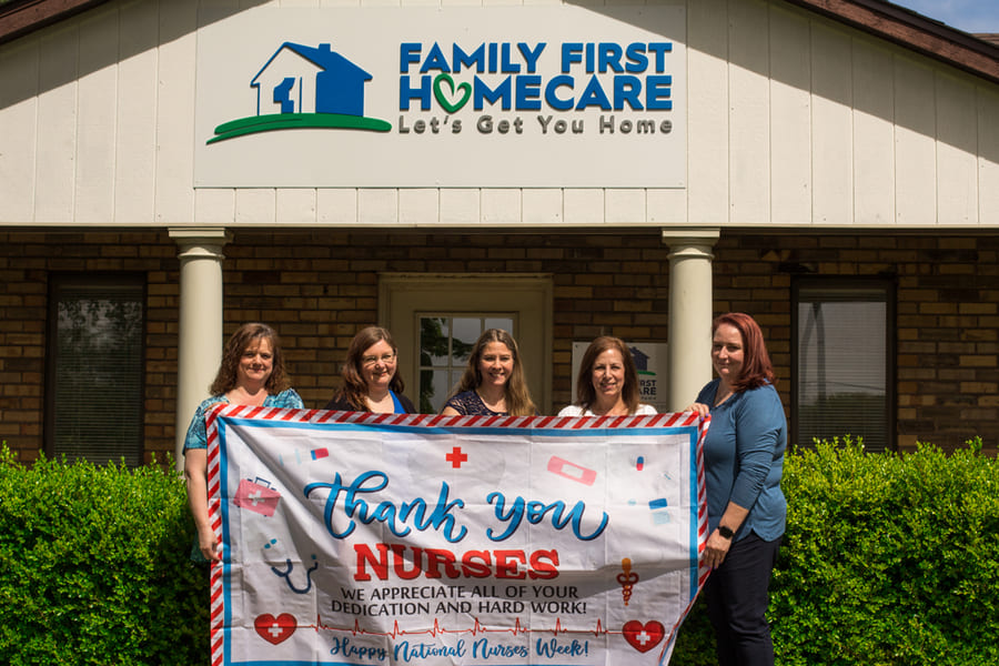 Five women holding up a sign that states "Thank you nurses" in front of the Family First Homecare Office