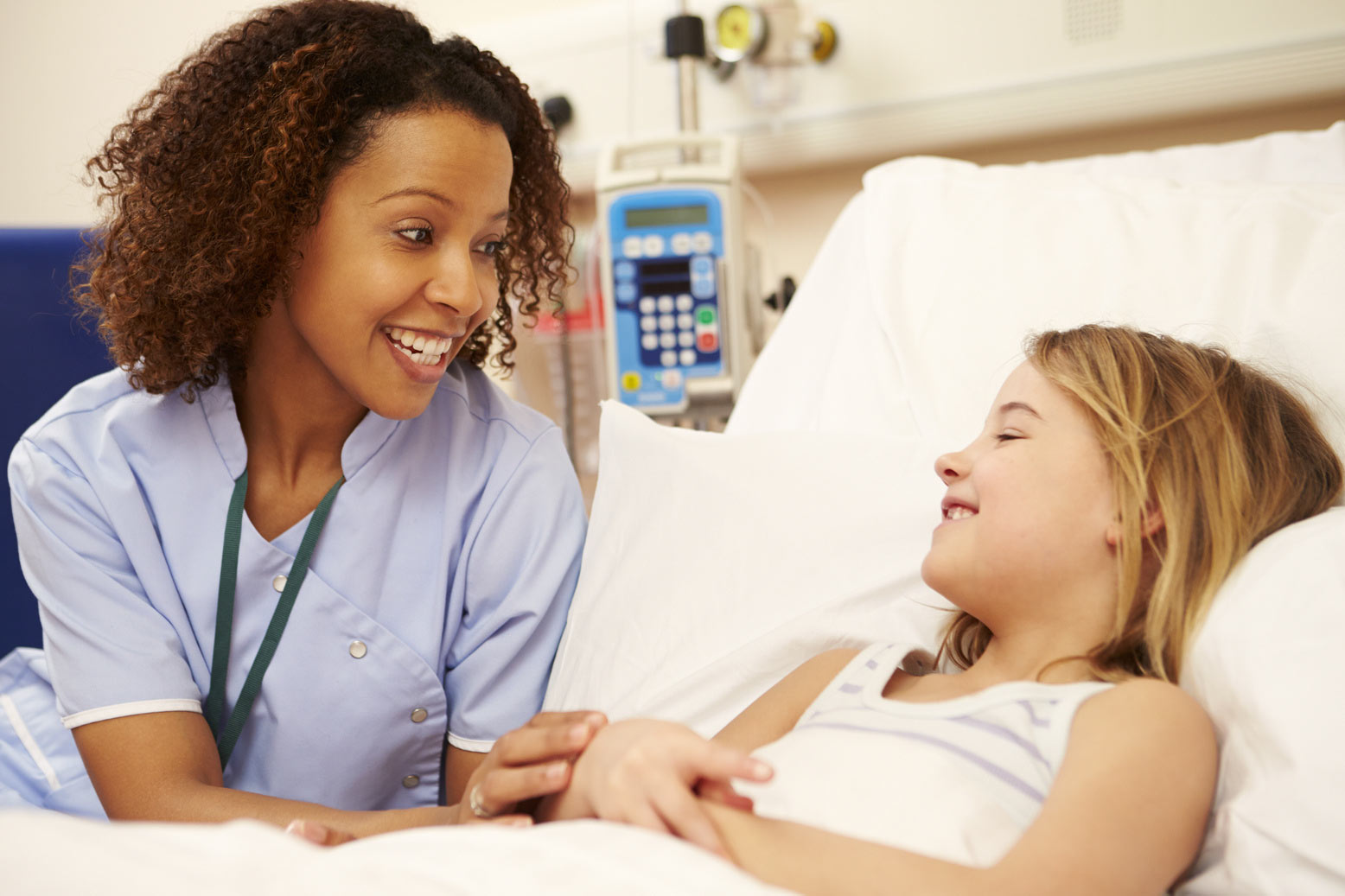 Nurse comforting smiling girl